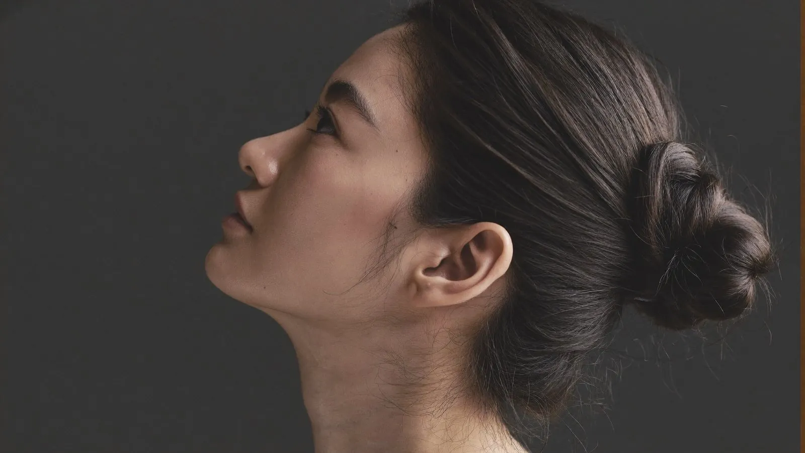 Dr Sin Yong assessing the submental area and jawline structure in clinic