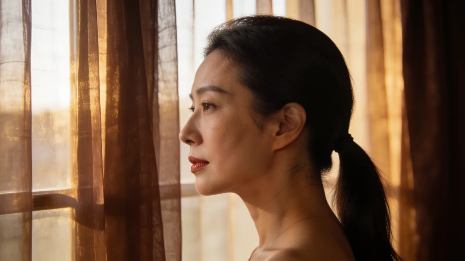 An East Asian woman in her 30s in side profile with a balanced chin and lip line — illustrative image
